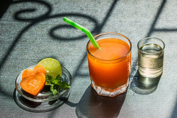 A glass of healthy carrot juice with ingredients