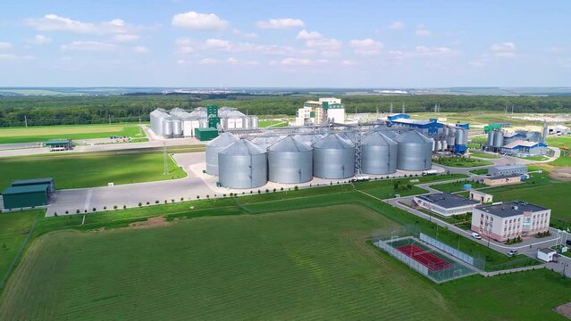 Large silver granary. Storage of grain. Factory for the production of mixed fodders. Factory for processing agricultural products. Feed Mill. Modern agricultural manufacture on field. Grain elevators 