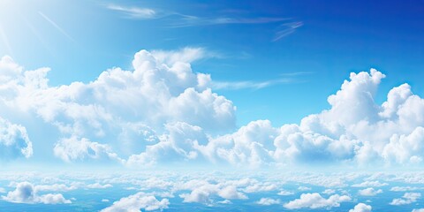 Beauty of summer sky with scattering of fluffy white clouds against backdrop of bright blue. Scene exudes tranquility and making ideal for aim to evoke calm and peaceful atmosphere - obrazy, fototapety, plakaty
