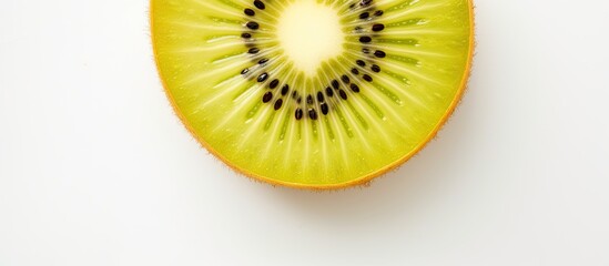 Top view of a sliced yellow kiwi fruit on a white table. - obrazy, fototapety, plakaty