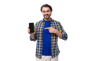 young caucasian brunette with a beard is dressed in a blue plaid shirt and t-shirt shows the...