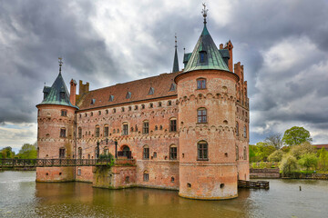 Fototapeta premium Denmark Egeskov Castle view on a cloudy spring day