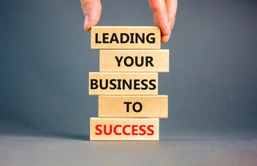 Leading your business to success symbol. Concept words Leading your business to success on wooden...