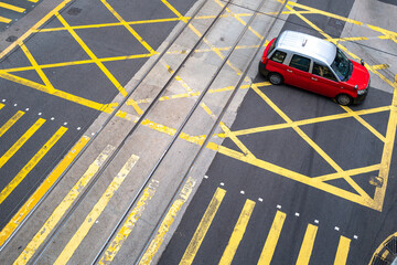 Red taxi driving through the road crossing in Hong Kong