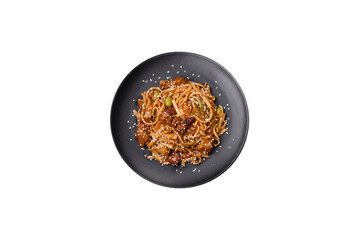 Delicious asian udon dish with vegetables, mushrooms, salt and spices