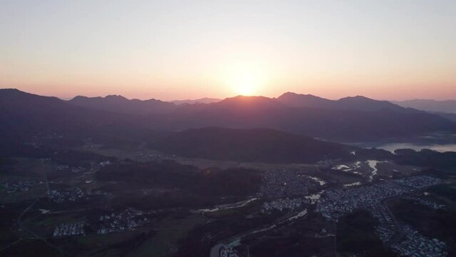Aerial view of Chinese ancient village, Lucun, Hongcun, Anhui, China. Drone fly view of traditional villages in sunny autumn morning, sunrise time, colorful autumn forest, 4k real time footage.