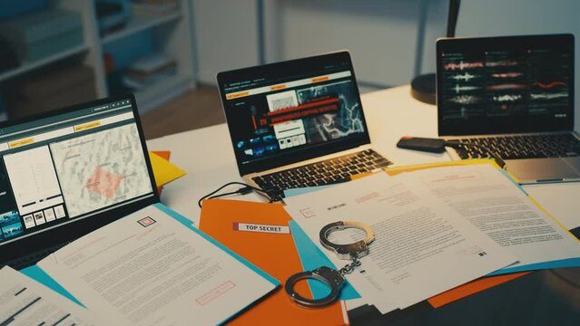 Handcuffs on desk, arrest for confidential military documentation and data leak