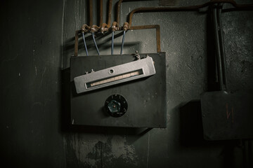 A strange rusty object in an abandoned bunker. Broken item. Gloomy atmosphere.