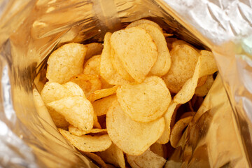 Fresh potato chips in a package. Top view, flat lay.