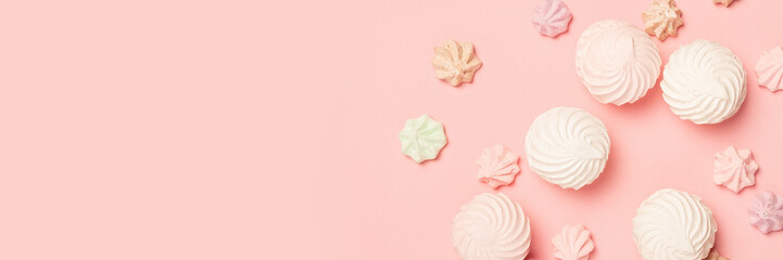 Sweets on a pastel pink background. Composition of confectionery. Flat lay, top view. Banner