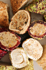 Many rolls of turkish delight with different flavors and fillings close up on table. Cutted Turk Lokumu bars