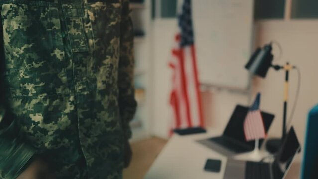 Close-up of a military man giving confidential papers to person in business suit