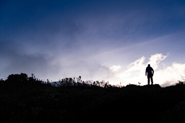 Man watching sunrise on Kilimanjaro