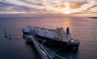 Aerial of Liquified Natural Gas LNG carrier moored to a small gas terminal. Fuel crisis. Sanctions - obrazy, fototapety, plakaty