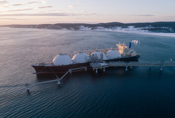Aerial of Liquified Natural Gas LNG carrier moored to a small gas terminal. Fuel crisis. Sanctions