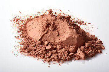 a pile of brown powder on a white surface