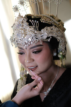 Asian Female Wedding Preparation doing makeup portrait of a woman with already using siger sundanese culture