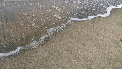  Transparent sea wave on the sand natural background