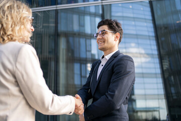 Meeting business young people managers, male and female partners go to the office to work, colleagues in business clothes, positive employees.