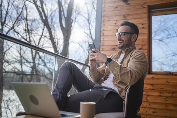 One adult man at home use smart phone app browse internet or send sms