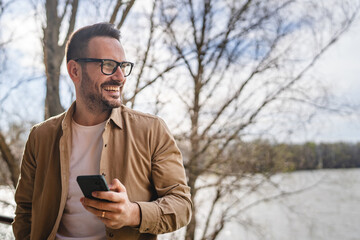 One adult man at home use smart phone app browse internet or send sms
