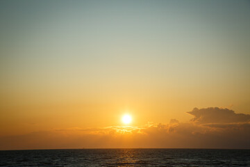 Beautiful sunset near the shore on the sea, background with sunset, orange sunset