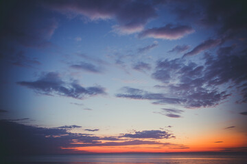 Beautiful sunset near the shore on the sea, background with sunset, orange sunset