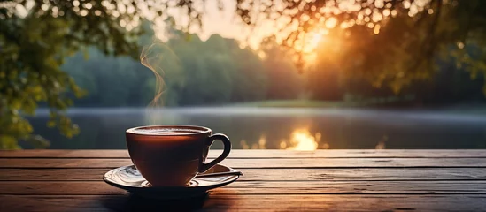 Zelfklevend Fotobehang Cup of tea on wooden table on blurred natural background © ART_ist