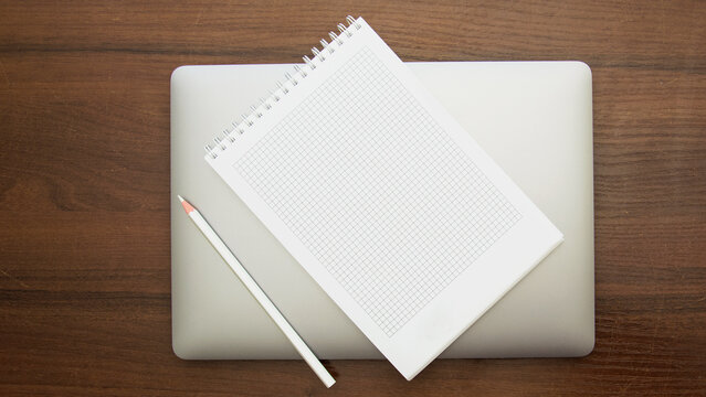 Notebook and pencil on a beautiful background in a large photo studio