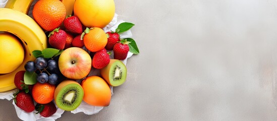Assorted fresh fruits in an eco-friendly bag on a tiled floor. Nutritious, vitamin-rich. Overhead view of juicy fruits.