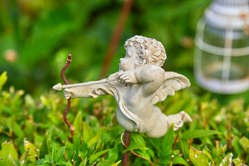 Funny cupid figure as garden decoration.
