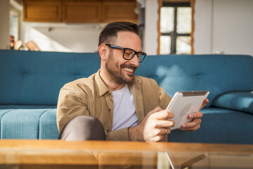 Fototapeta na wymiar One Man caucasian Holding Digital Tablet work at home Happy Smile