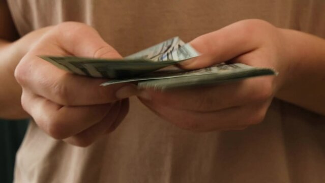 Women's hands count money close-up. Dollar bills. 4K footage