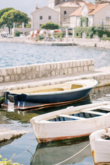 Fototapeta na wymiar Colorful wooden fishing boats are moored near the Perast pier. Montenegro