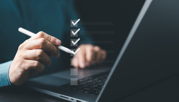 Business performance checklist. Businessman use pen to take online checklist surveys, digitally fill out forms, assessments, questionnaires, survey applications, online exams, or project evaluations.