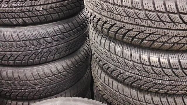 Tires in a stack ,rubber for car wheels with black tread ,lying in a stack in an auto supply store. concept transport traction