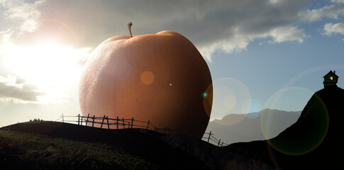 Giant peach at sunset in front of a cottage by the sea.