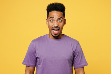 Young mad sad angry shocked man of African American ethnicity he wears purple t-shirt casual...
