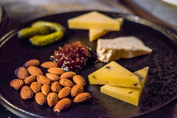 Cold cuts platter, variety of cheese with olives and nuts