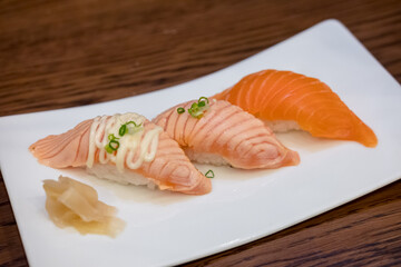 Set of Salmon aburi sushi with sauce on plate