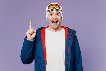 Skier happy man wear warm blue windbreaker jacket ski goggles mask hold index finger up with great...
