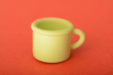 Toy cup isolated on a red background.