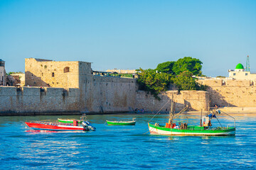 Akko or Acre city walls, a historic town in Israel. Citiscape featuring anchored boats