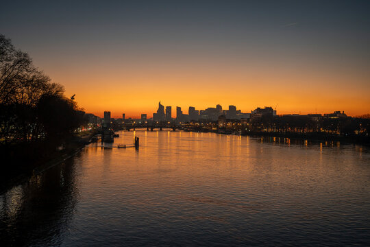 Gennevilliers, France - 12 17 2023: Panoramic view of the Seine river and La Defense towers district from Clichy bridge at sunset.
