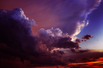 Black dark red burgundy purple magenta violet blue sky. Dramatic evening sunset background. Clouds...