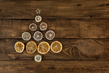 Fototapeta na wymiar Christmas tree made of slices of dried oranges, lemon and lime Creative Christmas and new year concept.