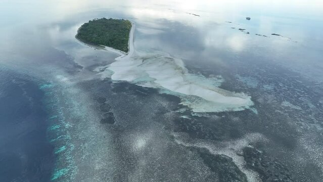 Early morning light illuminates the remote island of Koon near Seram, Indonesia. This scenic island's coral reefs, and the surrounding seas, support extraordinary marine biodiversity.