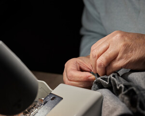 Women hands stitching and repairing clothes