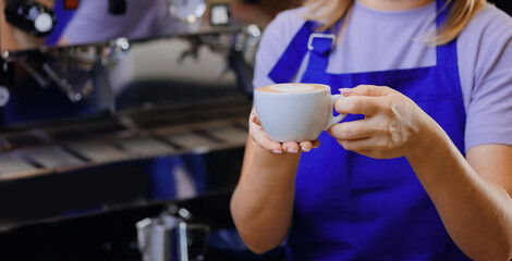 Barista make hot milk for latte art coffee on machine in craft cafe small business
