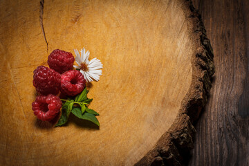 Red raspberries lie on a wooden surface, raspberries for dessert